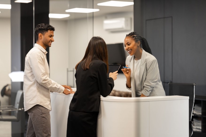 A receptionist greeting a customer. Source: Envato