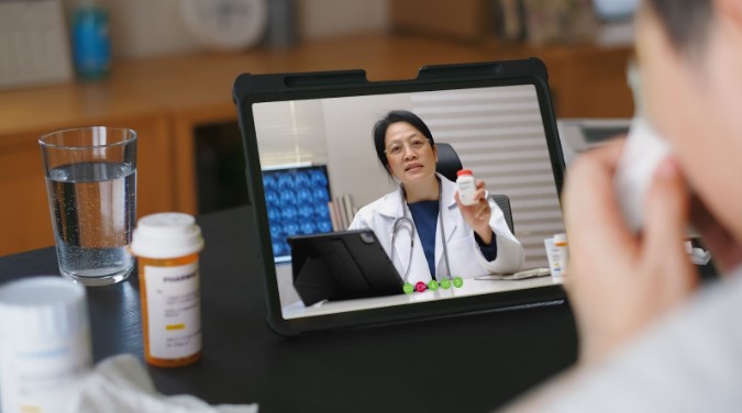 In a video conference, a doctor explains the prescribed medication. Source: Envato Elements